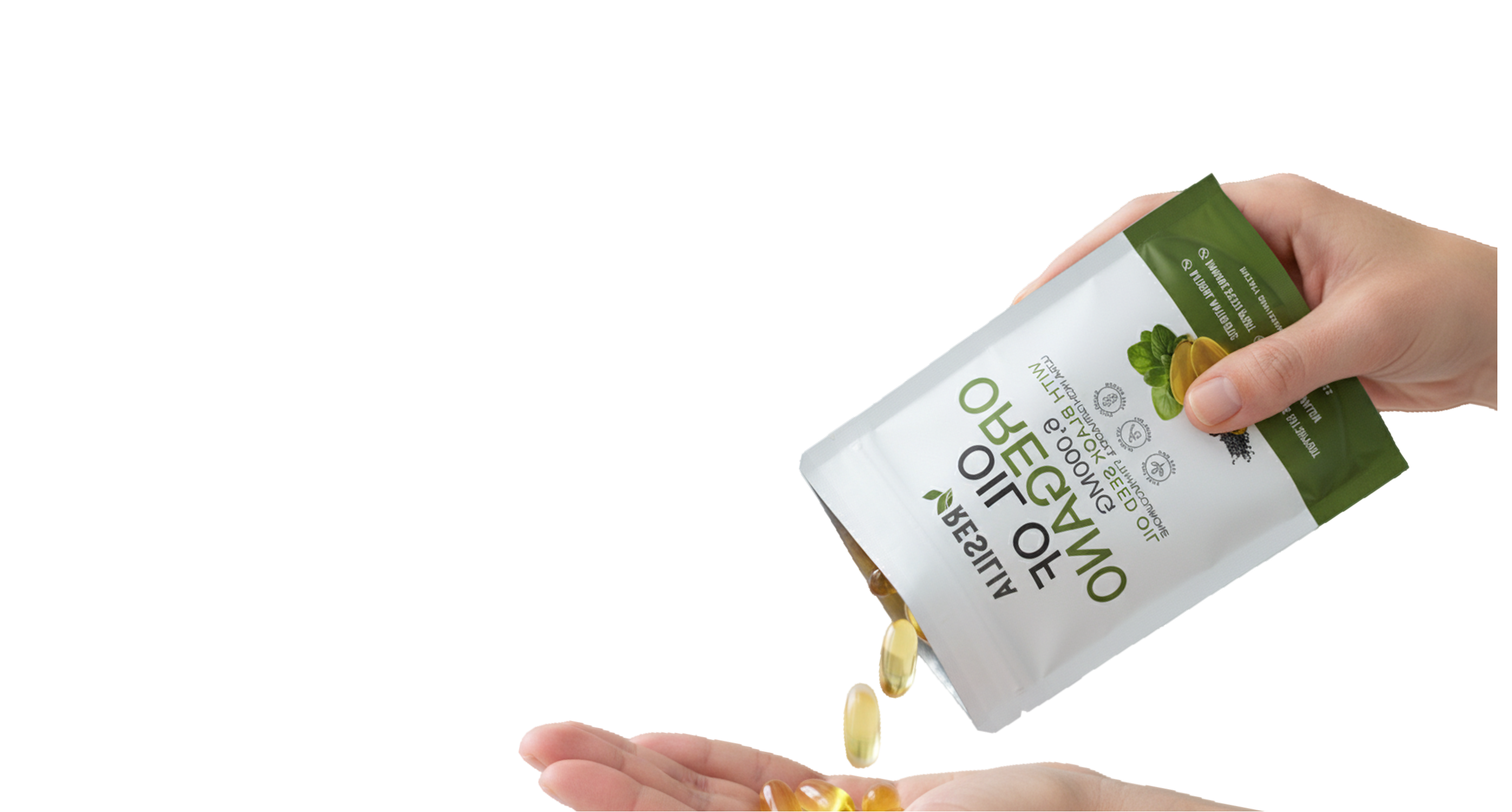 Hand pouring capsules from a supplement container labeled 'Natures Plus' on a white background