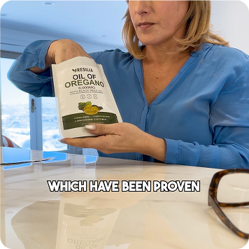 Woman holding a bottle of oregano oil with text overlay on a blurred background