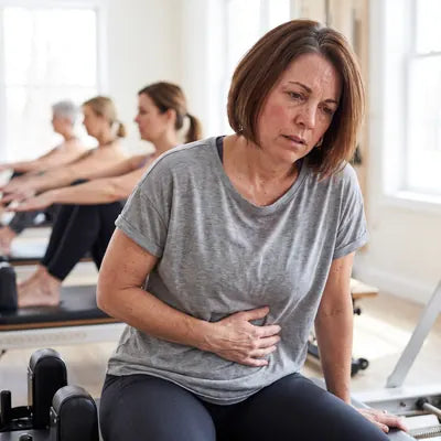 Denise exhausted on a pilates reformer