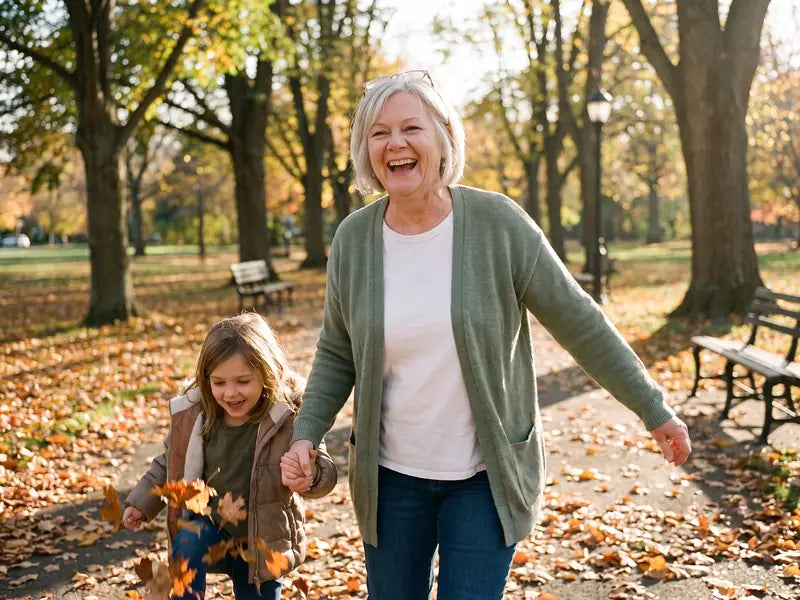 Linda laughing on a brisk afternoon walk with her granddaughter through autumn leaves