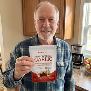Resilia customer holding the Aged Odorless Garlic pouch
