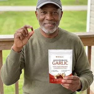 Resilia customer holding the Aged Odorless Garlic pouch