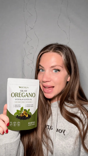 Resilia customer holding the Oil of Oregano pouch
