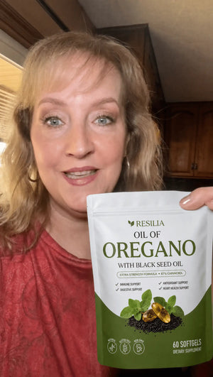 Resilia customer holding the Oil of Oregano pouch