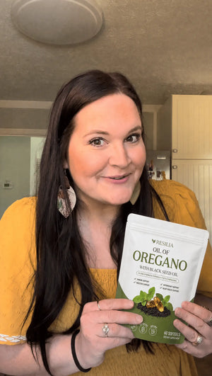 Resilia customer holding the Oil of Oregano pouch