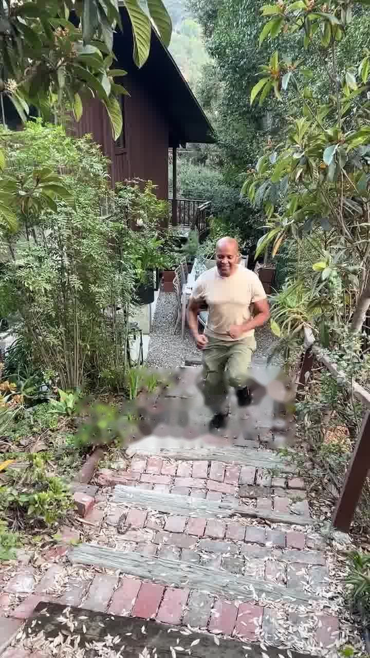A man jogging up a garden path