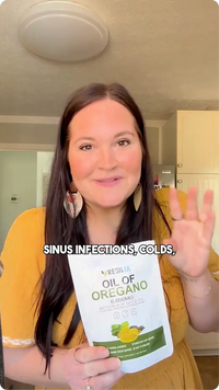 Woman holding a bottle of Oil of Oregano with text about sinus infections and colds.